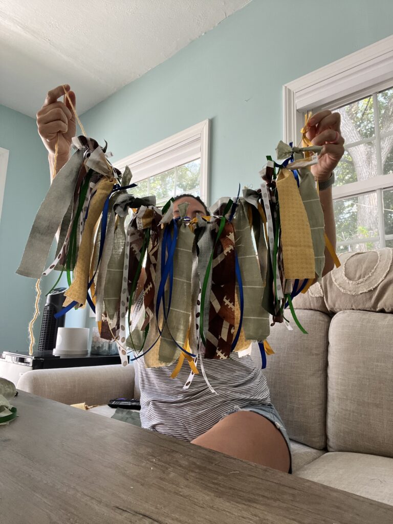 Garland of various ribbon colors, green, yellow, blue, white, football themed ribbon on a string.