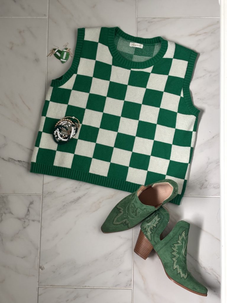 Top view of kelly green checkered sweatervest and green short cowboy booties.