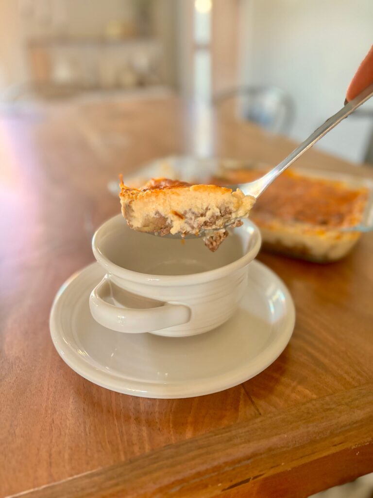 Side view of shepherds pie being placed into a bowl to be eaten.