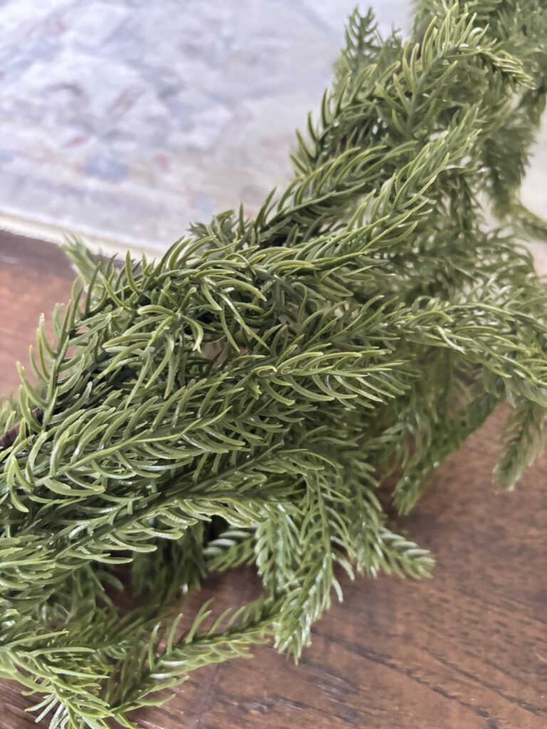 Close-up view of Norfolk pine garland, with pine needles looking very realistic.